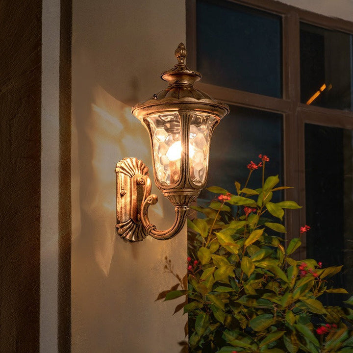 "Outdoor waterproof bronze wall light with clear water glass shade, elegant design for stylish exterior lighting."