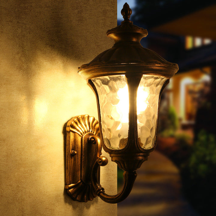 "Outdoor waterproof bronze wall light with clear water glass shade, elegant design for stylish exterior lighting."