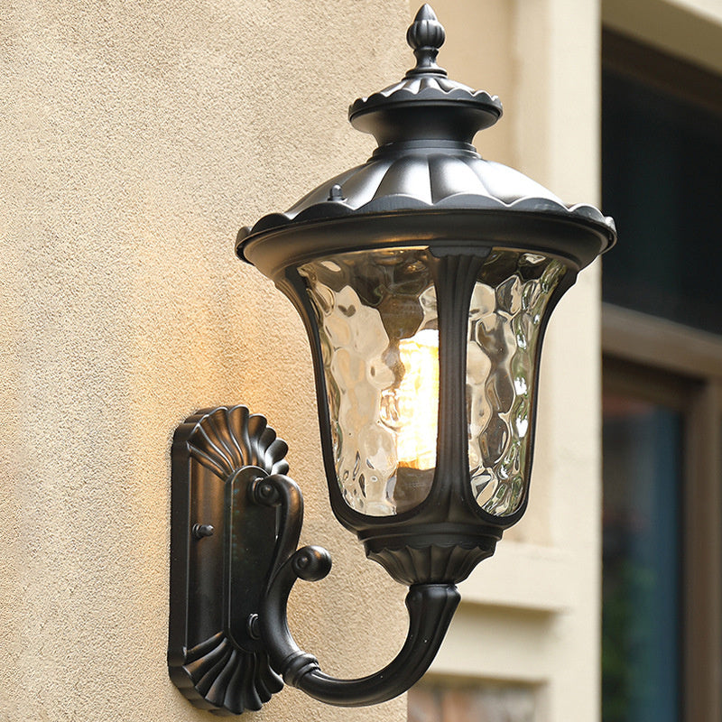 "Outdoor waterproof bronze wall light with clear water glass shade, elegant design for stylish exterior lighting."