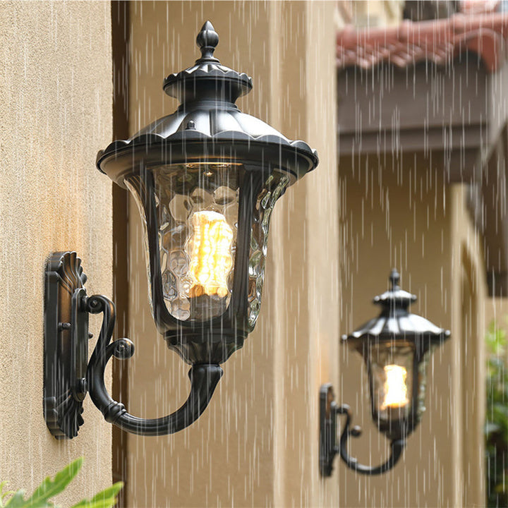 "Outdoor waterproof bronze wall light with clear water glass shade, elegant design for stylish exterior lighting."