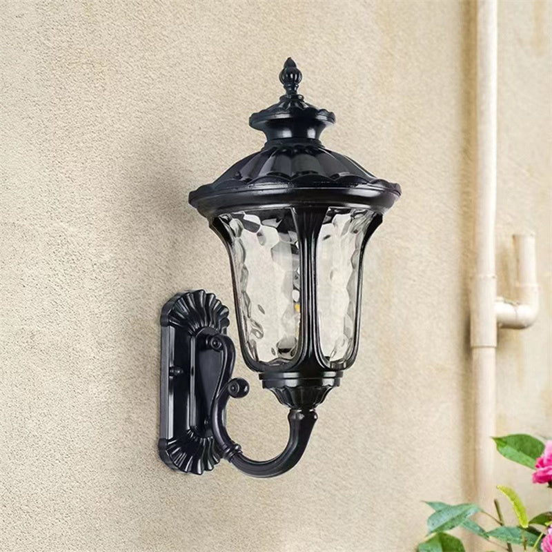 "Outdoor waterproof bronze wall light with clear water glass shade, elegant design for stylish exterior lighting."