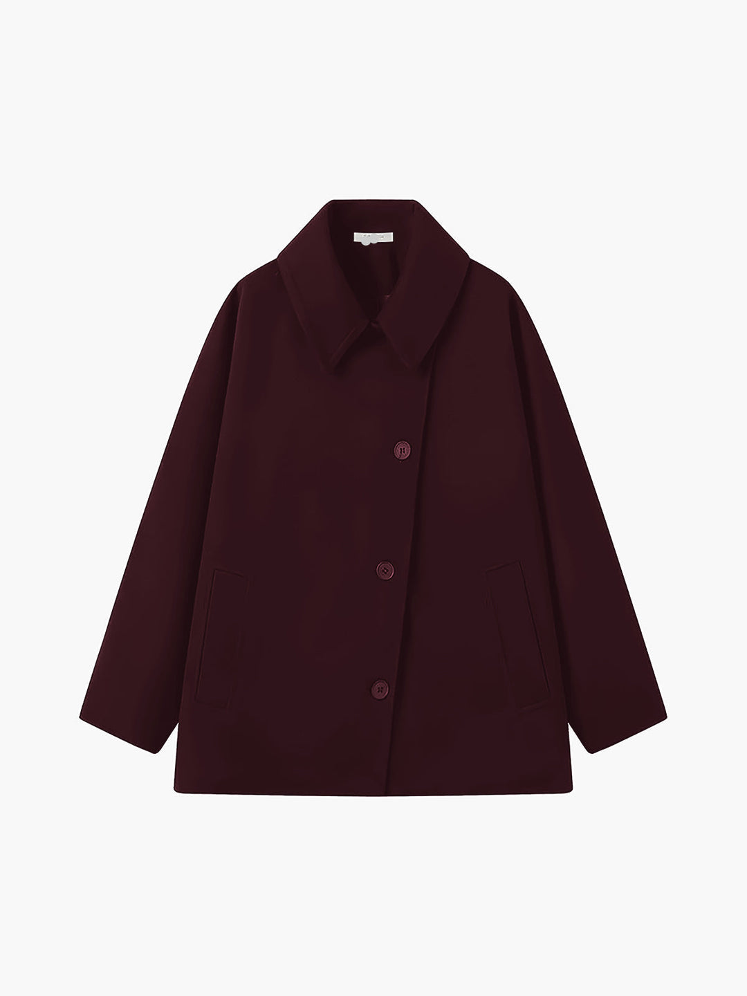 Detail shot: Button closure on a stylish oversized women's coat, highlighting the relaxed fit and design.