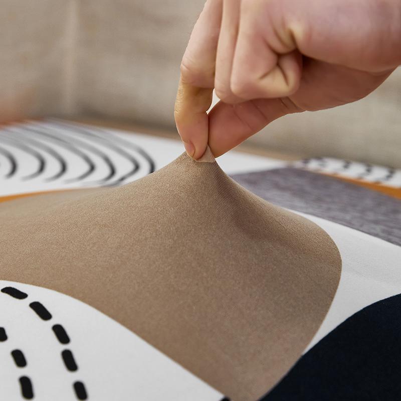 "Patterned Sunray Sofa Cover fitting snugly on a loveseat, with vibrant colors and a stylish design, enhances living space."