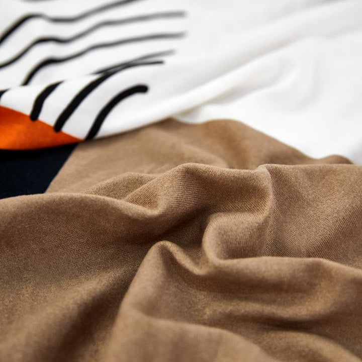 "Patterned Sunray Sofa Cover fitting snugly on a loveseat, with vibrant colors and a stylish design, enhances living space."