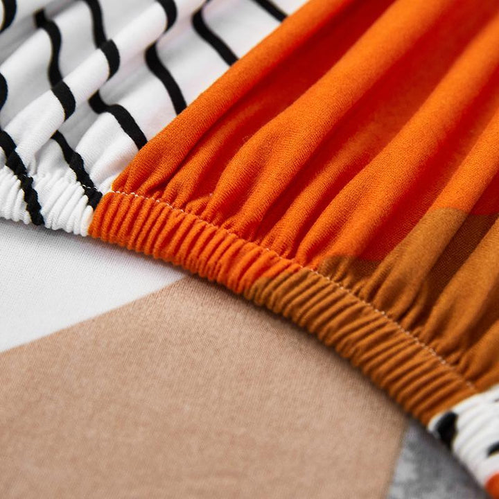 "Patterned Sunray Sofa Cover fitting snugly on a loveseat, with vibrant colors and a stylish design, enhances living space."