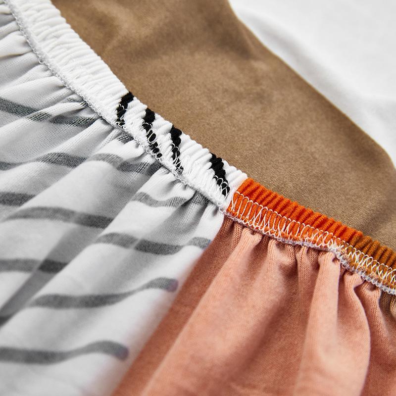 "Patterned Sunray Sofa Cover fitting snugly on a loveseat, with vibrant colors and a stylish design, enhances living space."