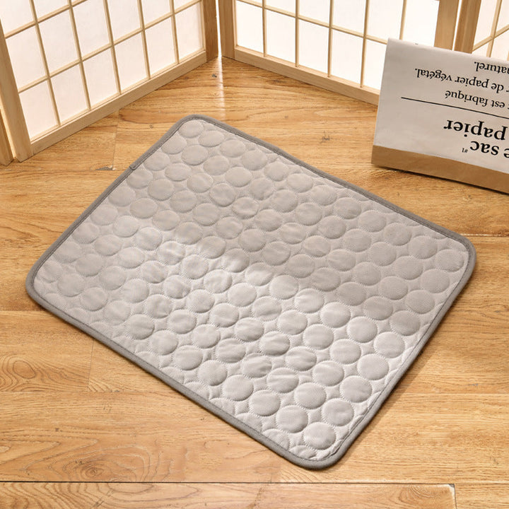 "Pet cooling pad in light blue, ideal for summer. Features breathable, machine-washable fabric, available in multiple sizes."