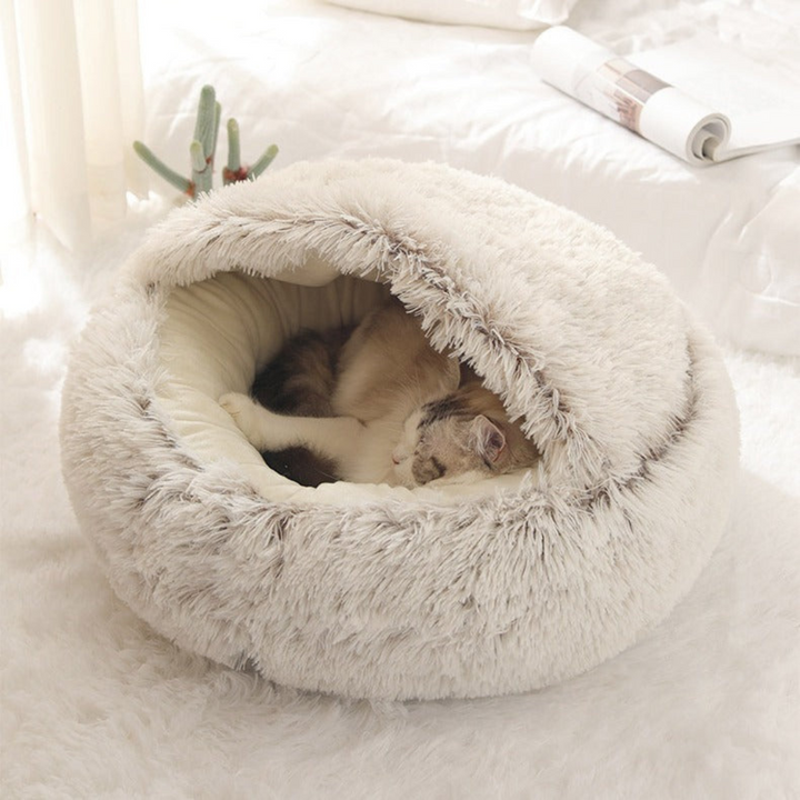 "Plush cat cuddle cave with hood, featuring a cozy, covered design for warmth and comfort in pet supplies product."