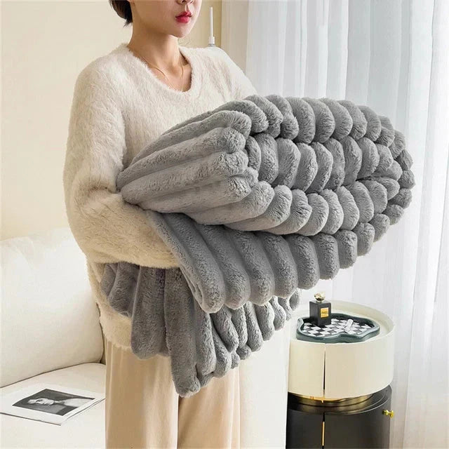 Velvety soft comfort blanket, offering unparalleled warmth and a touch of luxury to any room decor.