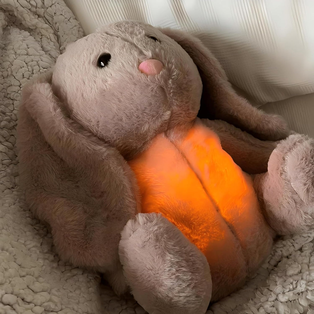 Plush teddy for kids with glowing nightlight, soothing heartbeat, realistic breathing; provides comfort and relaxation.