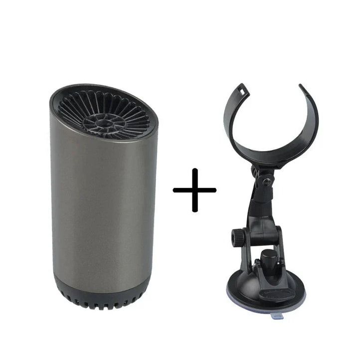 Driver using a portable car heater to quickly clear a foggy windshield on a cold morning commute.
