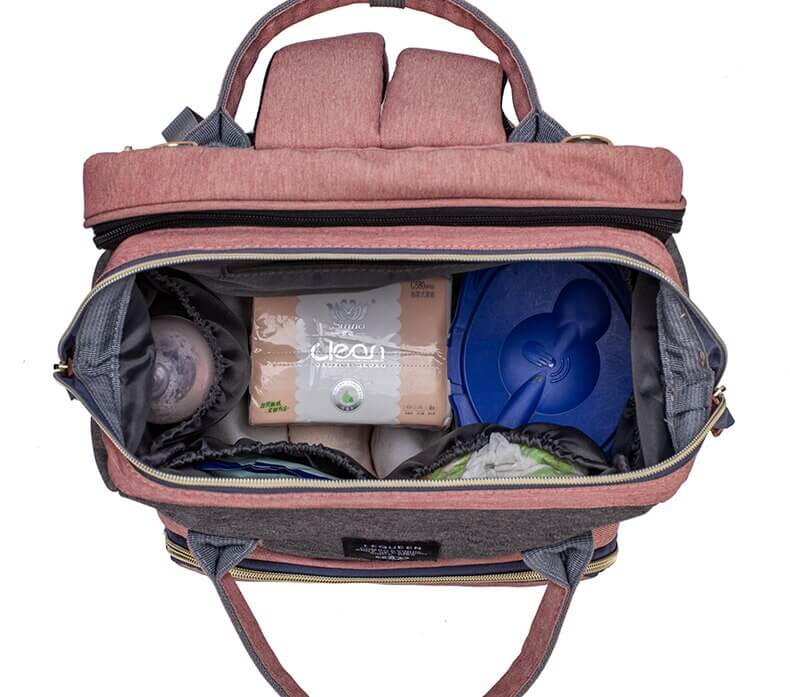 Organized baby travel backpack with accessible pockets and a convertible sleep space.