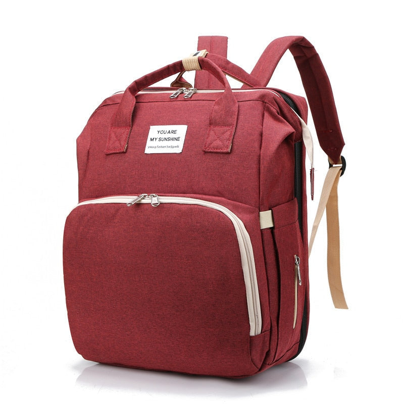 Ergonomic baby travel backpack with spacious compartments and integrated changing pad.