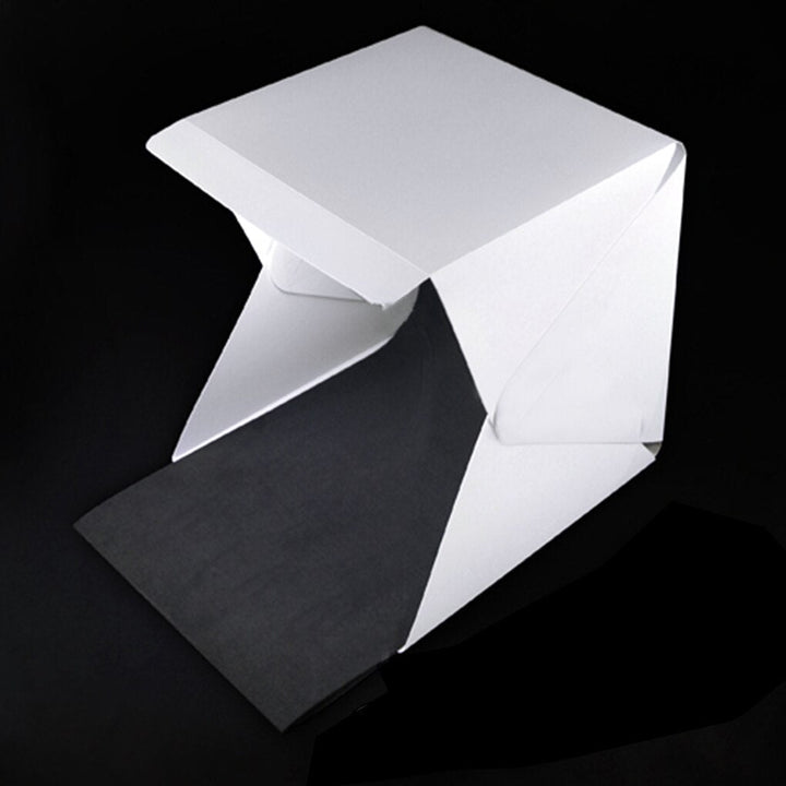 Mini photography light tent with adjustable LED lights & multiple backdrops. Easy setup for product shots.