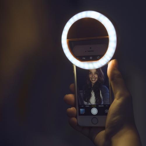 Mini portable LED ring light for phones, ensuring professional lighting for selfies & videos.