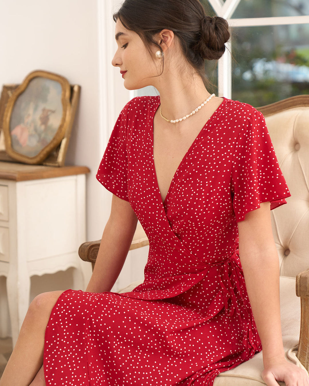 Elegant women's short sleeve wrap midi dress with red polka dots, ideal for special occasion guests.