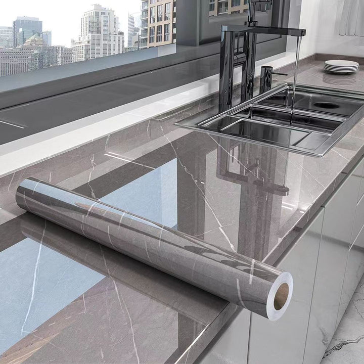 Self-adhesive grey marble kitchen countertop wrap. Oil-resistant, waterproof contact paper for DIY surface cover.