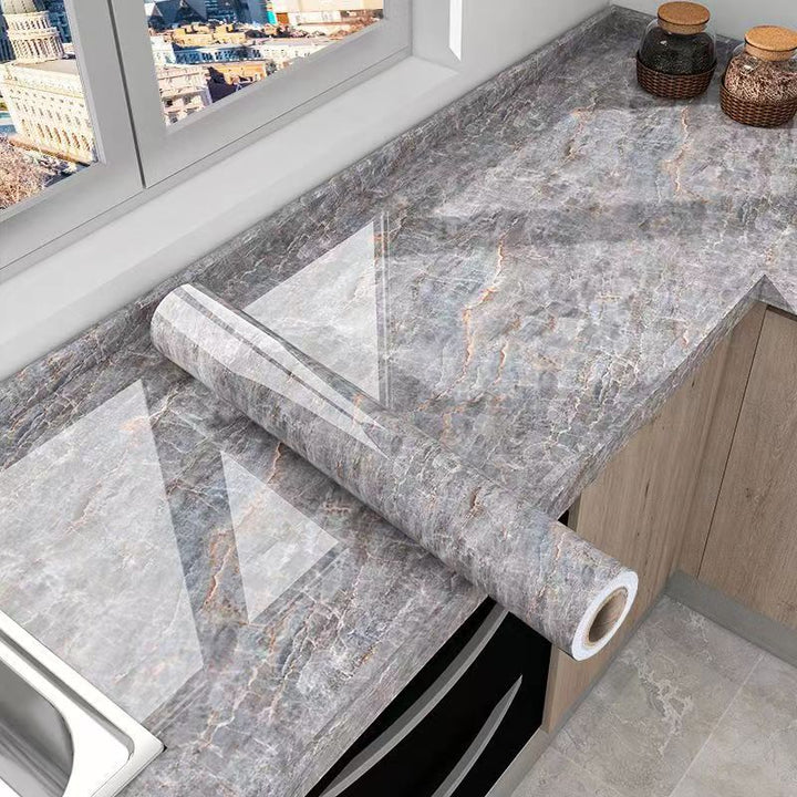 DIY white marble adhesive film for kitchen countertops. Waterproof, oil-resistant surface protector and home decor.