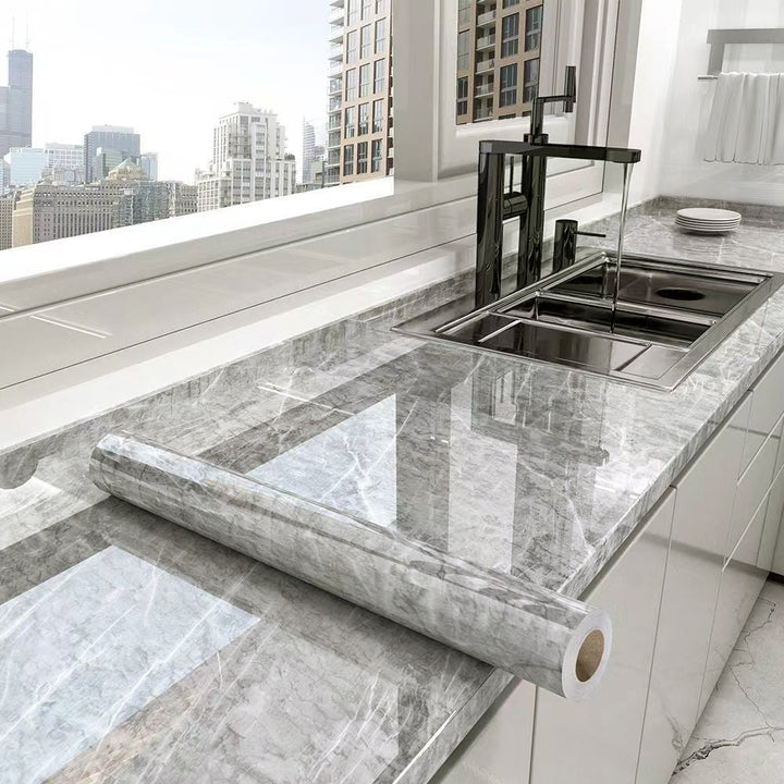 Marble adhesive kitchen counter wrap. Waterproof, oil-resistant film protects surfaces with stylish stone pattern.