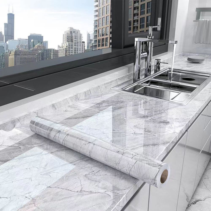 Easy-to-apply self-adhesive marble film for kitchen countertops. Oil-resistant, waterproof surface wrap decor.