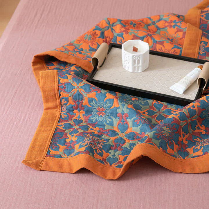 Beautiful six-layer orange & blue pattern cotton quilt by TerraLoom, enhancing cozy bedroom comfort.