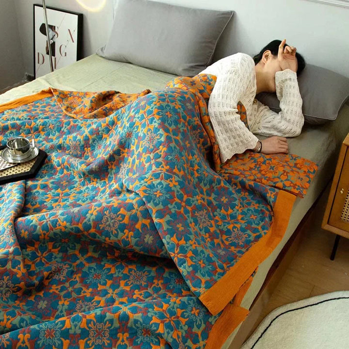 Soft TerraLoom six-layer cotton quilt with vibrant orange & blue pattern for comfortable bedding.