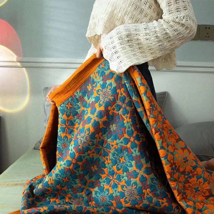 Cozy & comfortable six-layer orange & blue cotton quilt, ideal bedding for a warm bedroom.