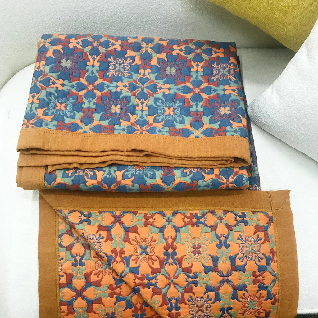 Plush six-layer cotton quilt with a vibrant orange & blue pattern, perfect for comfortable bedroom bedding.