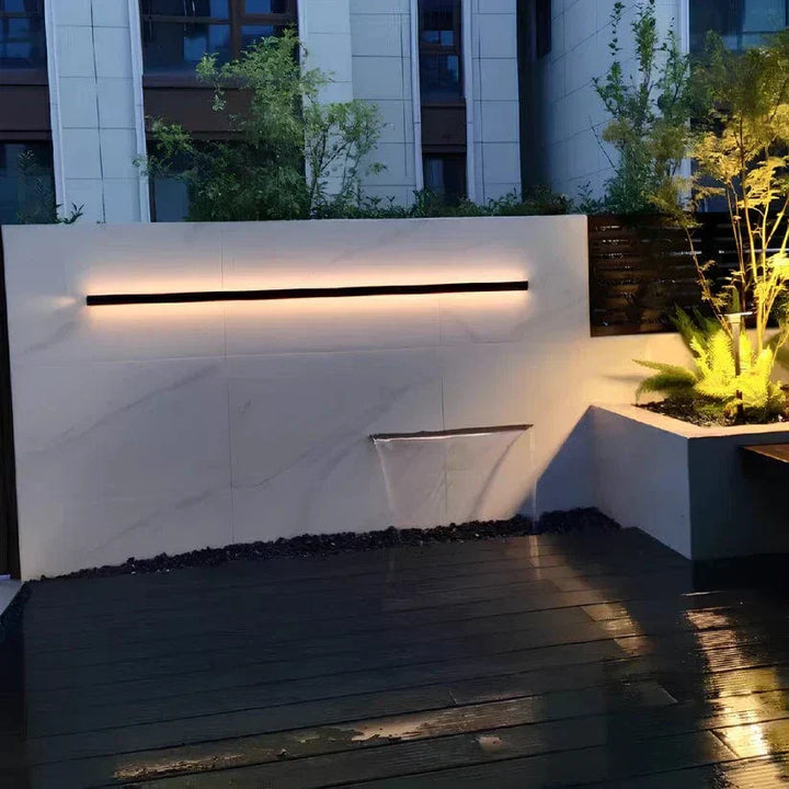 Sleek aluminium outdoor wall sconce with backlit design, ideal for modern patios; corrosion-resistant and stylish.