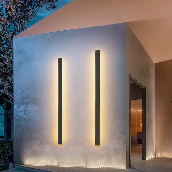 Sleek aluminium outdoor wall sconce with backlit design, ideal for modern patios; corrosion-resistant and stylish.
