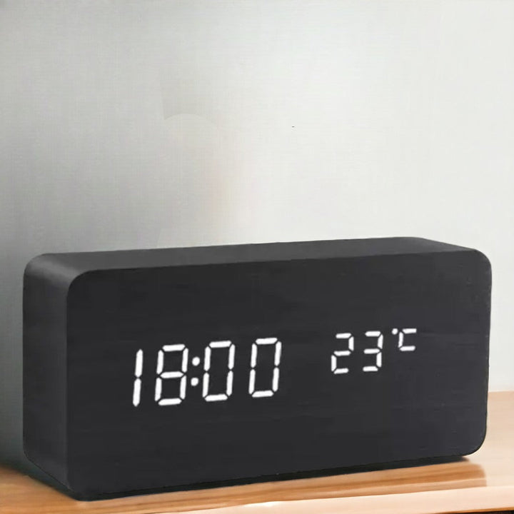 Digital LED alarm clock with voice activation, perfect for bedroom or home office.