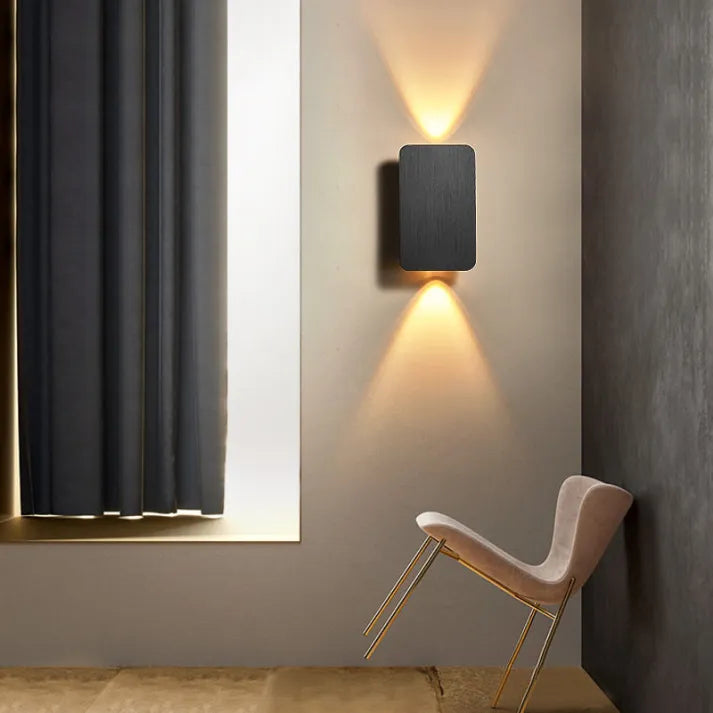 "Sleek indoor LED wall lamp with a modern rectangular design, featuring smooth finishes and warm illumination for elegant dec