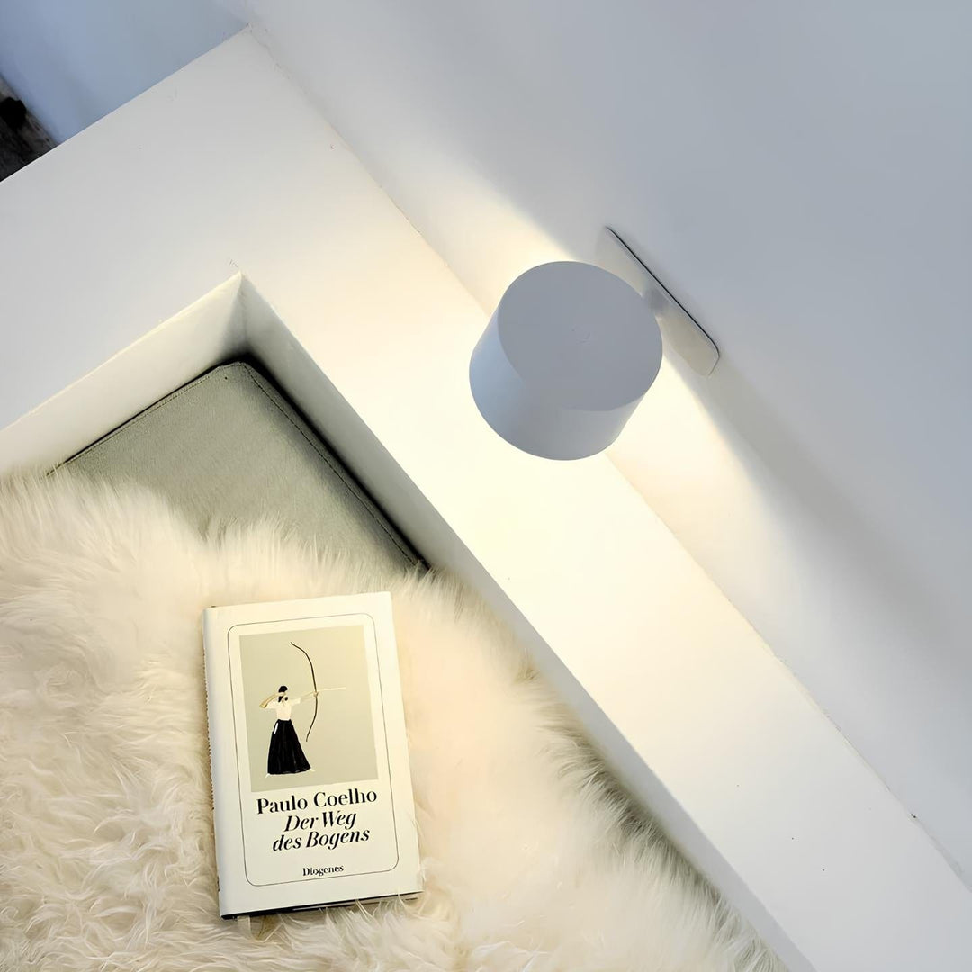 "Sleek wireless rechargeable wall light with magnetic mount and 360° rotation for modern home interiors."