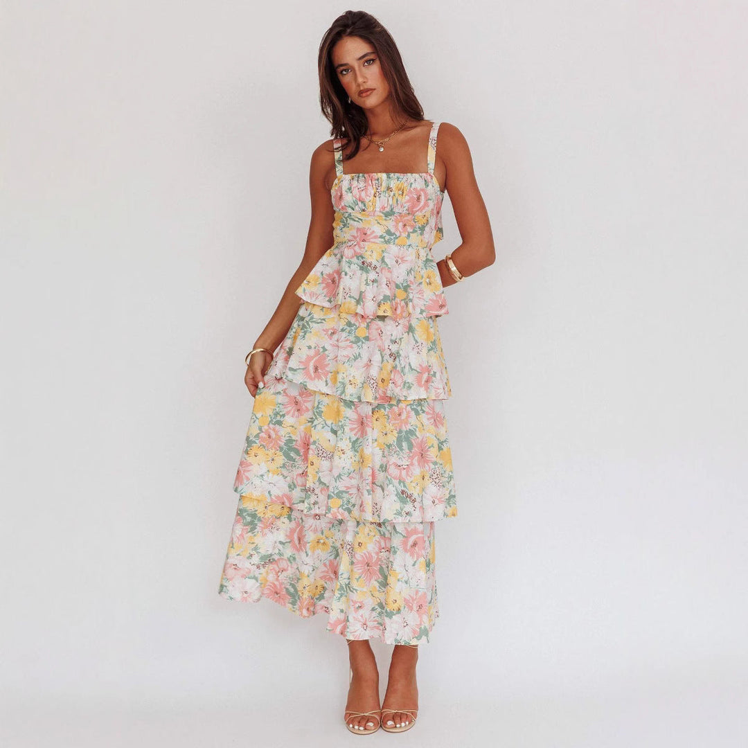 "Sleeveless floral midi dress with ruffled skirt, highlighting elegant slim-fit bodice in vibrant spring colors."