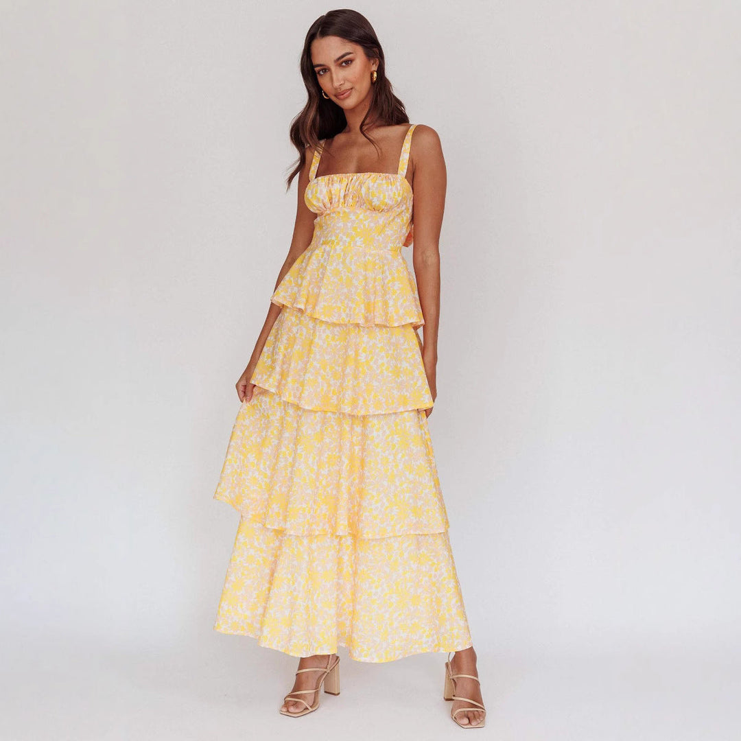 "Sleeveless floral midi dress with ruffled skirt, highlighting elegant slim-fit bodice in vibrant spring colors."