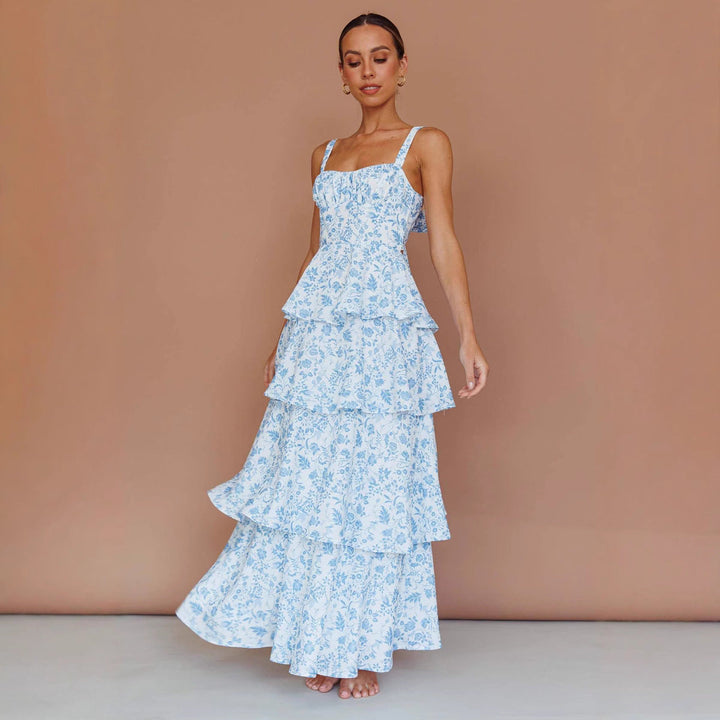 "Sleeveless floral midi dress with ruffled skirt, highlighting elegant slim-fit bodice in vibrant spring colors."