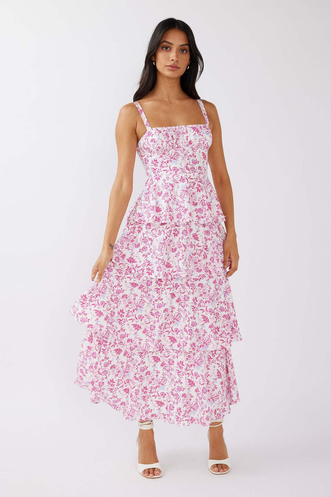 "Sleeveless floral midi dress with ruffled skirt, highlighting elegant slim-fit bodice in vibrant spring colors."