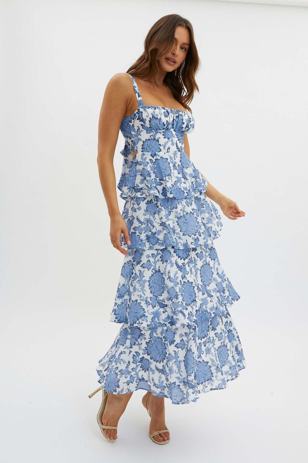 "Sleeveless floral midi dress with ruffled skirt, highlighting elegant slim-fit bodice in vibrant spring colors."