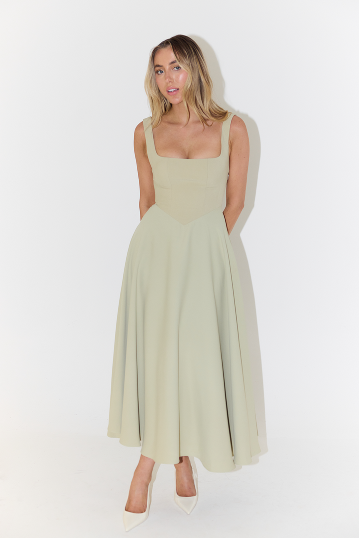 "Sleeveless satin midi dress with square neckline, fitted bodice; elegant women's fashion for special occasions."