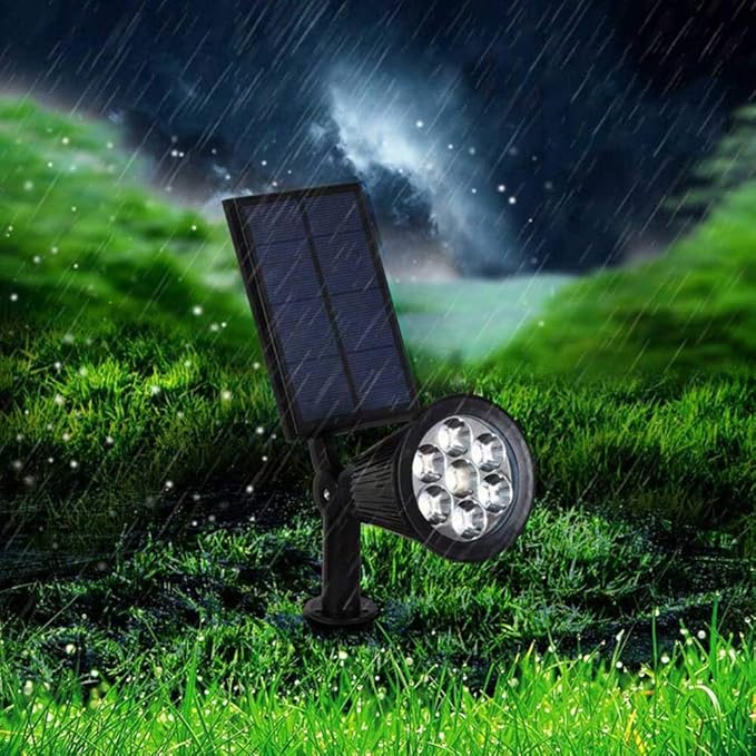 "Solar-powered LED garden spotlight with 9 color options, illuminating a pathway; eco-friendly outdoor lighting solution."