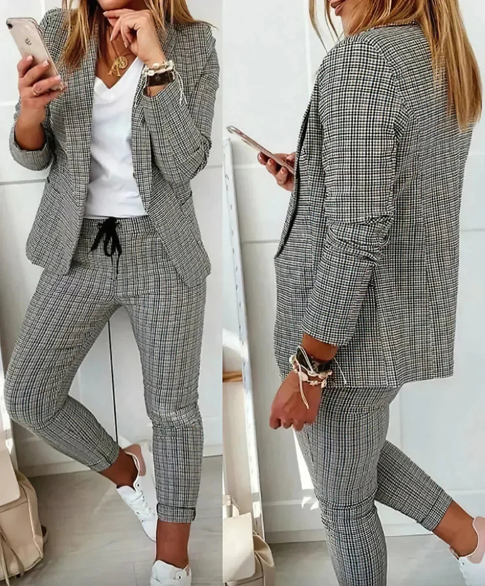 Elegant gray women's two-piece suit, perfect blazer & pants set for formal office and business wear.