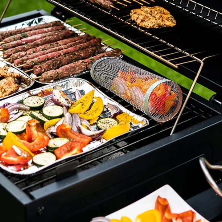 "Stainless steel BBQ rolling basket with mesh design for even grilling, shown with food; essential for outdoor cooking."