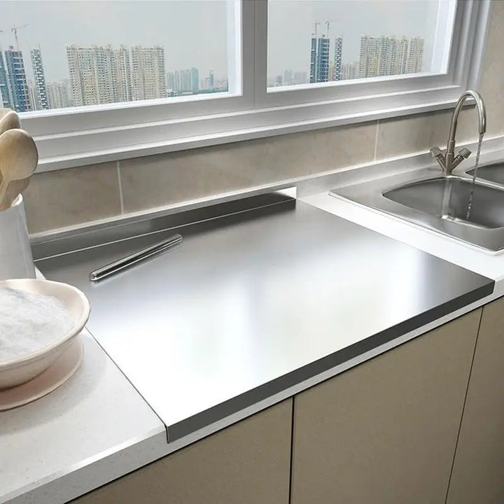 Stainless steel chopping board with non-slip silicone pads, sleek finish, ideal for meat, fish, veggies slicing.