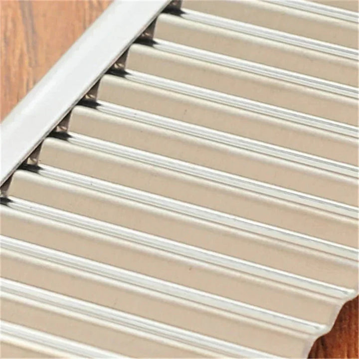 "Stainless steel crinkle cutter knife with a sleek blade, perfect for slicing vegetables and fruits with ergonomic handle."