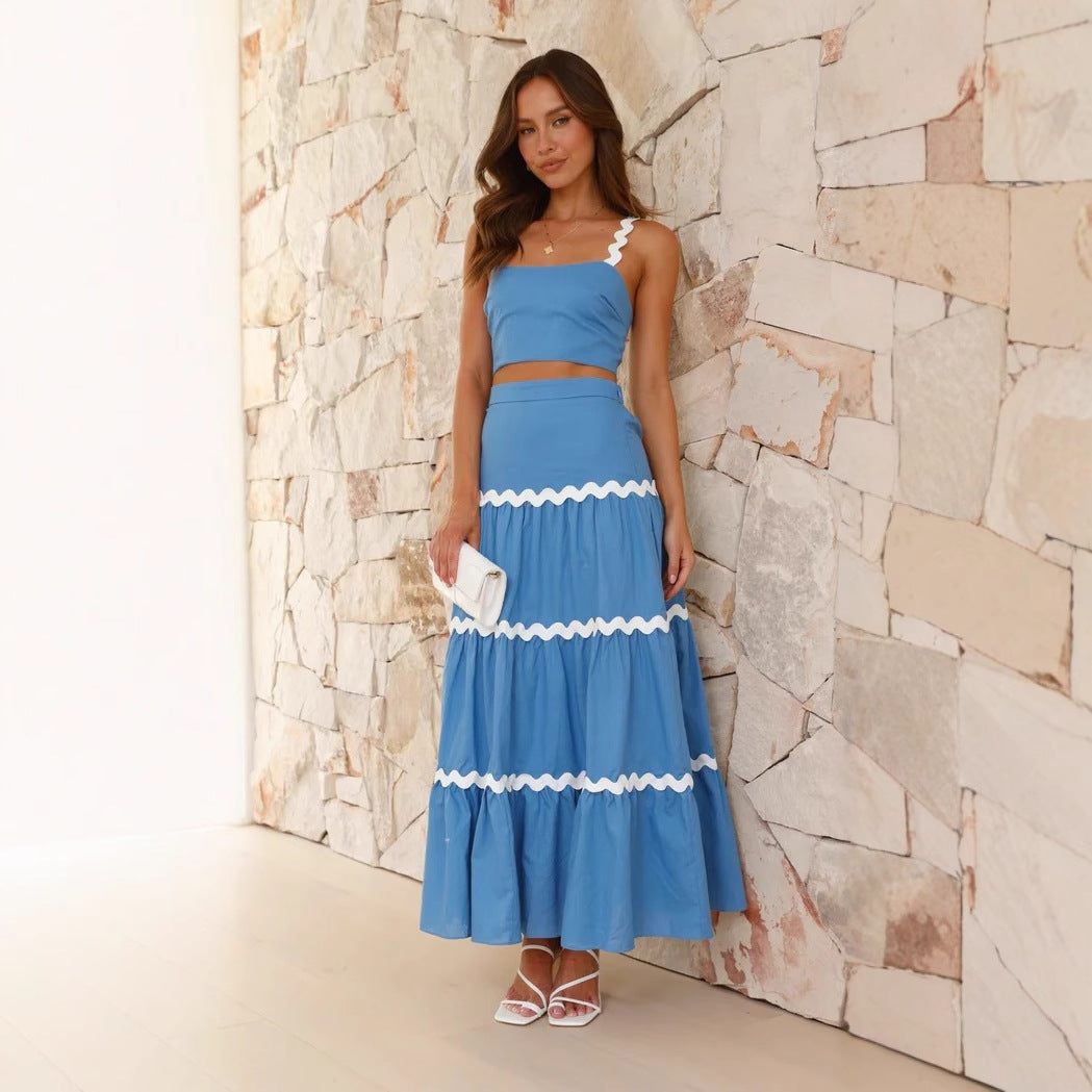 Strapless crop top and tiered maxi skirt set, lightweight with wavy trim, perfect for summer events. Women's fashion ensemble