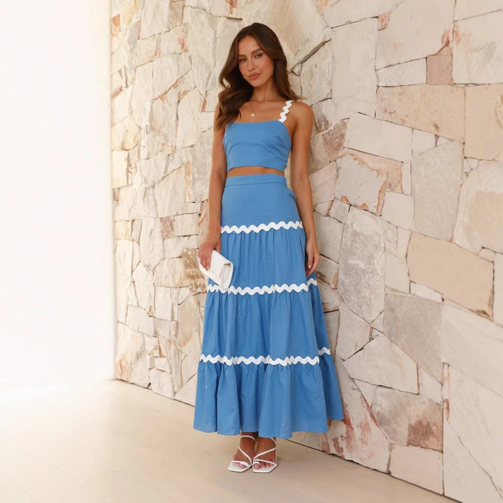 Strapless crop top and tiered maxi skirt set, lightweight with wavy trim, perfect for summer events. Women's fashion ensemble