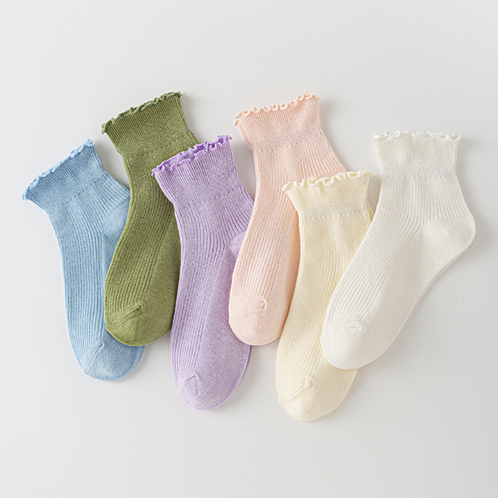 Stylish white women's ruffle ankle socks, perfect for a playful, year-round fashion accessory.
