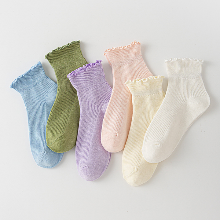Stylish white women's ruffle ankle socks, perfect for a playful, year-round fashion accessory.