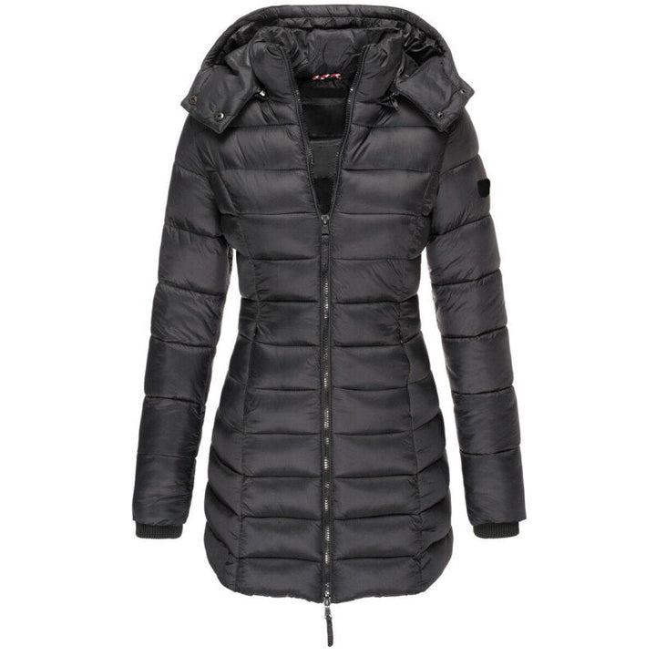 Close-up of a women's insulated puffer jacket with a warm hood. Detailed view of the stylish stitching & durable fabric.