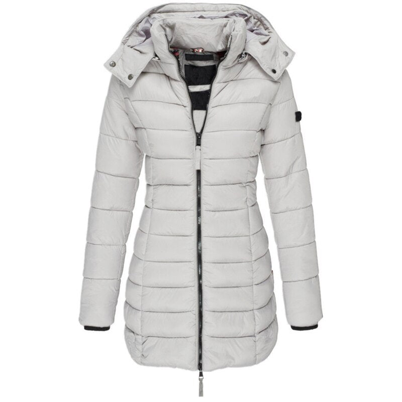 Active woman wearing a stylish hooded winter puffer jacket, enjoying the outdoors. Warm and practical cold weather outerwear.